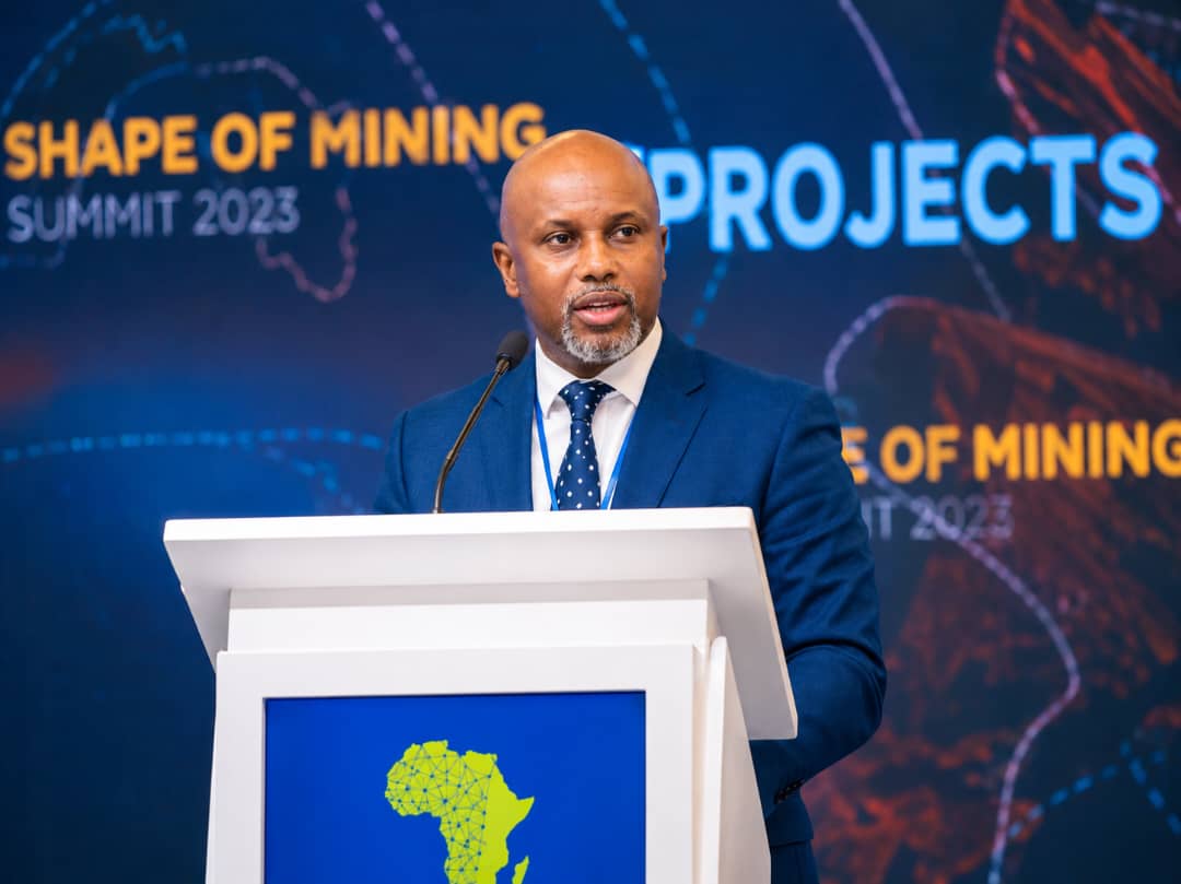 Lesego Osman speaking at a conference podium