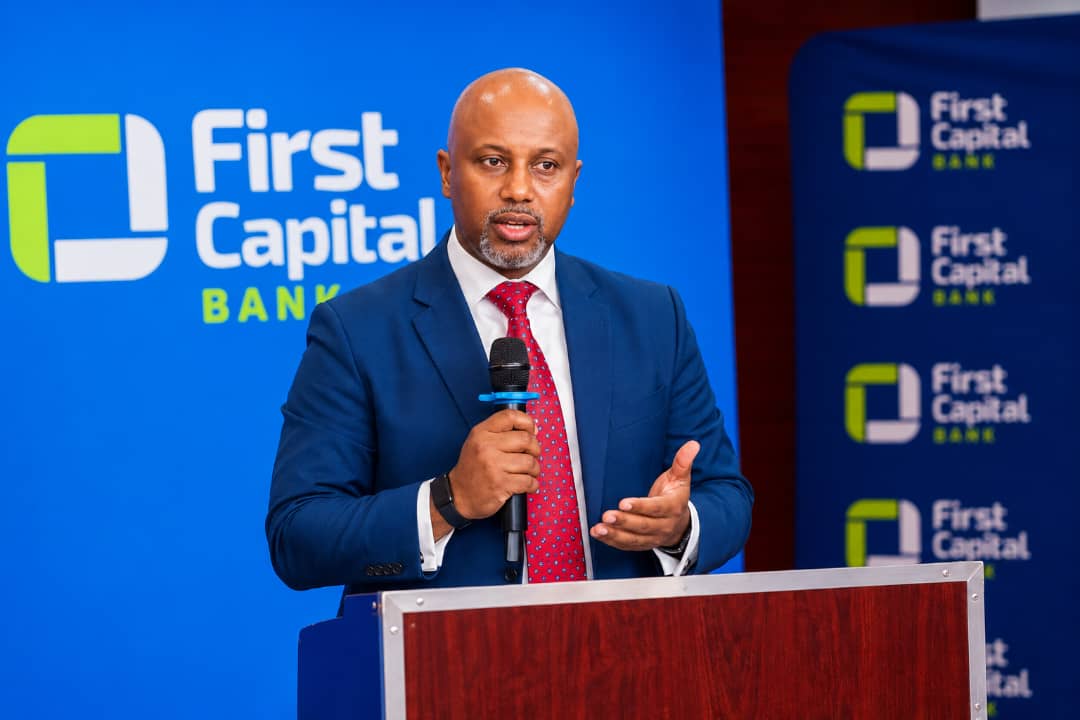 Lesego Osman speaking with a handheld microphone